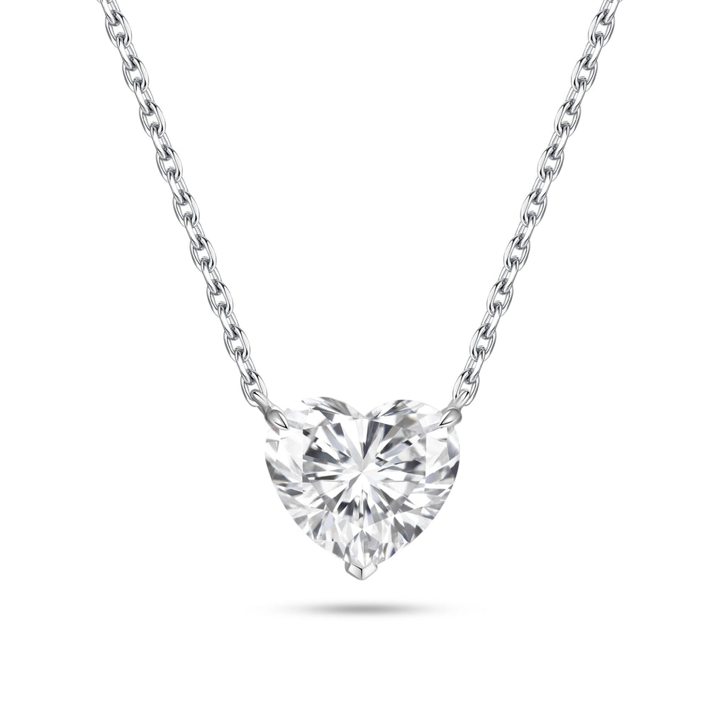 Front view of the J'ENCHANTE ONE heart-cut diamond solitaire necklace in white gold. Centered on a perfectly balanced, brilliant heart-shaped stone, the pure and minimalist design captures light effortlessly, offering a romantic and unmistakable statement of elegance.