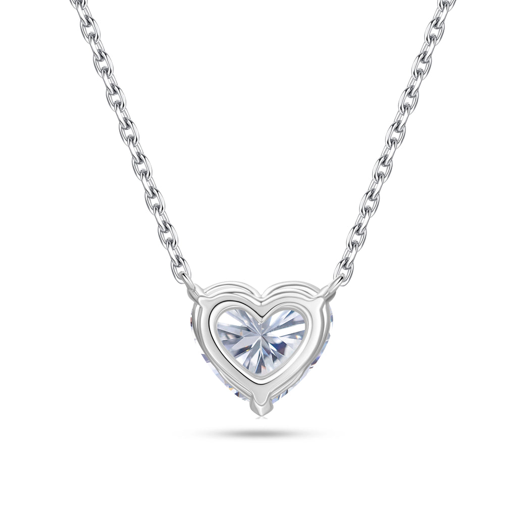 Back gallery view of the J'ENCHANTE ONE heart diamond necklace, showcasing the signature J-setting and open-backed structure. The graceful architectural curve flows seamlessly into the pendant, maximizing light passage from behind to lift the diamond and enhance its radiant brilliance.