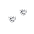 Front view of the J'ENCHANTE ONE heart-cut diamond stud earrings in white gold. The minimalist design features a brilliant heart-shaped center stone on each ear, beautifully highlighting its romantic silhouette and pure, distinctive brilliance.