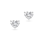 Front view of the J'ENCHANTE ONE heart-cut diamond stud earrings in white gold. The minimalist design features a brilliant heart-shaped center stone on each ear, beautifully highlighting its romantic silhouette and pure, distinctive brilliance.