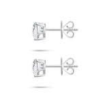 Side profile view of the J'ENCHANTE ONE heart diamond stud earrings, highlighting the signature J-setting and secure earring backs. The refined architectural curve cradles the heart-cut stone from the side, allowing light to enter freely to enhance its depth and radiant brilliance.