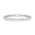 J'ENCHANTE ONE medium diamond tennis bracelet in white gold, featuring a breathtaking continuous sequence of round brilliant diamonds totaling approximately 12.51 carats. Each 0.30-carat stone is architecturally cradled in the signature J-setting to maximize light return, delivering a bold and unforgettable statement presence.
