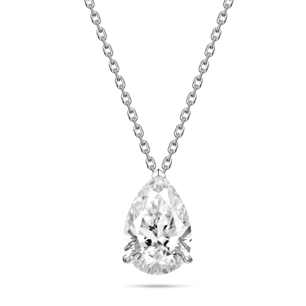 Front view of the J'ENCHANTE ONE pear-cut diamond solitaire necklace in white gold. Suspended on a delicate chain, the brilliant pear-shaped focal stone is defined by soft, architectural lines and a protective V-prong at the tip. The elegant, elongated silhouette expresses pure brilliance born from a single, graceful curve.