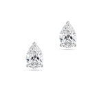 Front view of the J'ENCHANTE ONE pear-cut diamond stud earrings in white gold. Featuring a brilliant pear-shaped focal stone on each ear, the minimalist design perfectly balances soft, graceful curves with refined, precise definition for a clean and intentional statement.