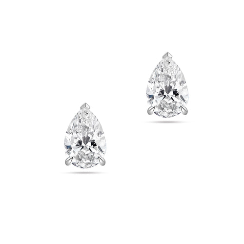 Front view of the J'ENCHANTE ONE pear-cut diamond stud earrings in white gold. Featuring a brilliant pear-shaped focal stone on each ear, the minimalist design perfectly balances soft, graceful curves with refined, precise definition for a clean and intentional statement.