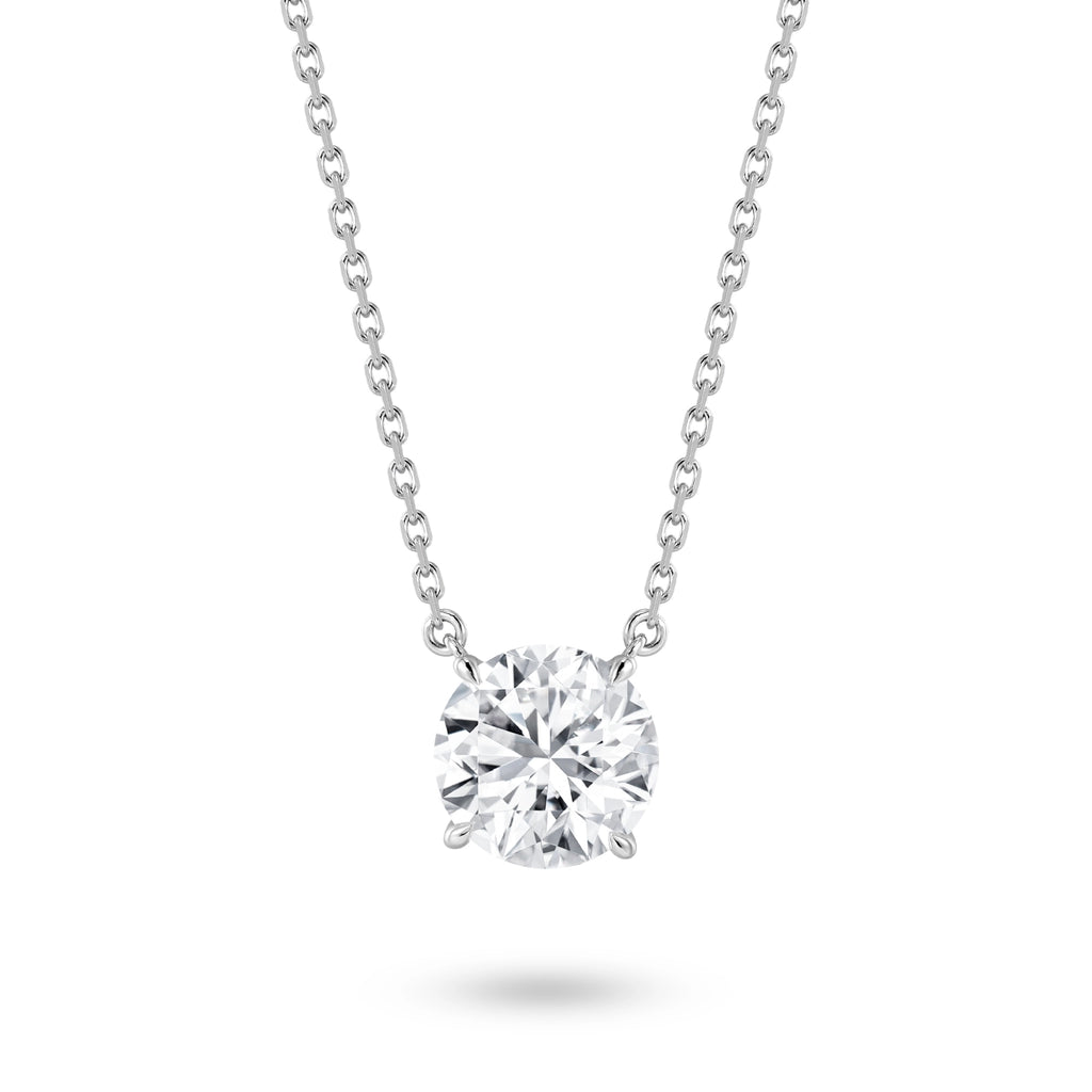 Front view of the J'ENCHANTE ONE round cut diamond solitaire necklace, featuring a breathtaking 3-carat brilliant center stone. The minimalist white gold design allows the diamond to appear floating, catching light with every movement for a timeless expression of elegance.