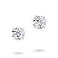 Front view of the J'ENCHANTE ONE round cut diamond stud earrings, featuring a magnificent 2-carat brilliant round diamond on each ear. Free from embellishment, the minimalist white gold design expresses the purest relationship between form and light.