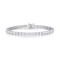 J'ENCHANTE ONE small diamond tennis bracelet in white gold, featuring a seamless, fluid array of round brilliant diamonds totaling approximately 6.85 carats. Each 0.15-carat stone is cradled in the signature J-setting—an elegant architectural arch designed to maximize light return for delicate everyday elegance.