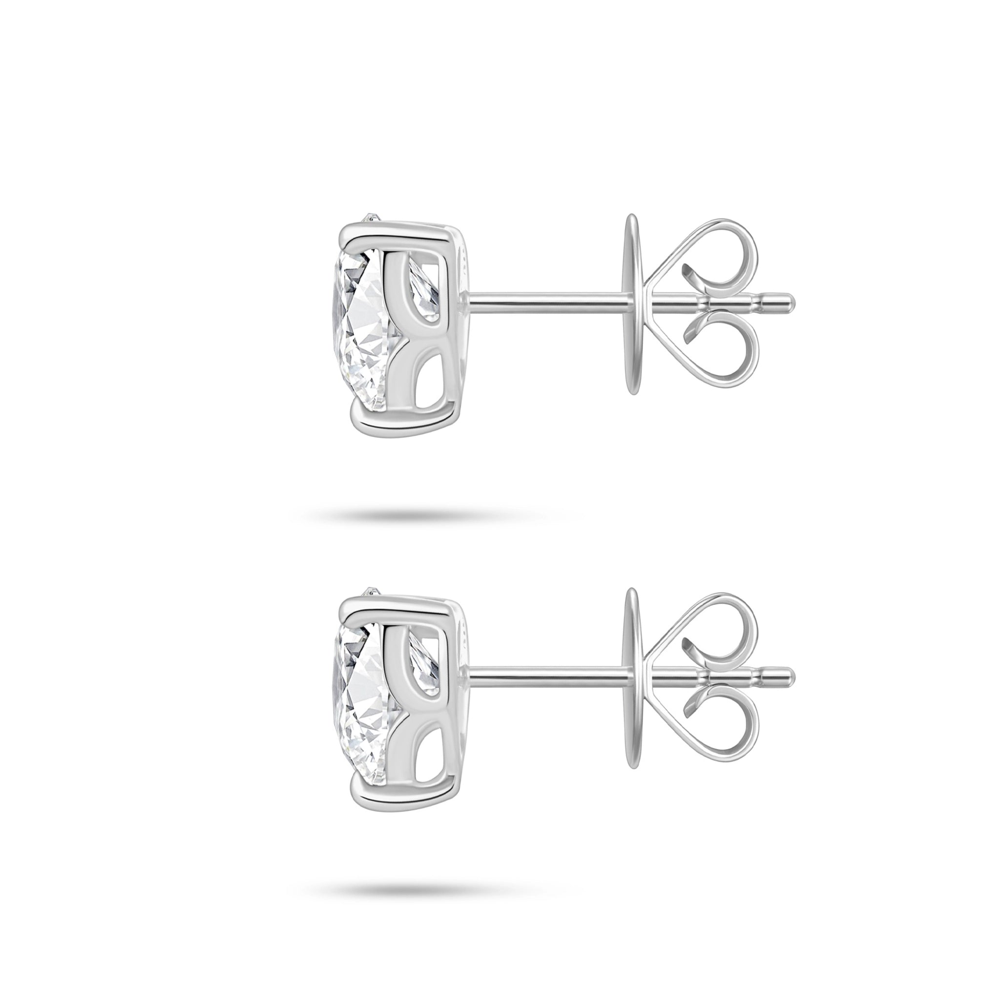 Side profile view of the J'ENCHANTE ONE trilliant diamond stud earrings, highlighting the signature J-setting. The sculpted architectural curve beautifully elevates the stone, allowing maximum side light entry to enhance the depth and brilliance of this unique geometric cut.