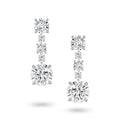 Front view of the J'ENCHANTE The Radiant Line diamond earrings in 18K white gold. Defined by a pure vertical composition, a precise sequence of graduating round brilliant diamonds unfolds into two commanding 3.0-carat bottom anchor stones (10 diamonds totaling approx. 9.08 carats). This flawless alignment creates a continuous, luminous flow of radiance for an elegant and effortless statement.