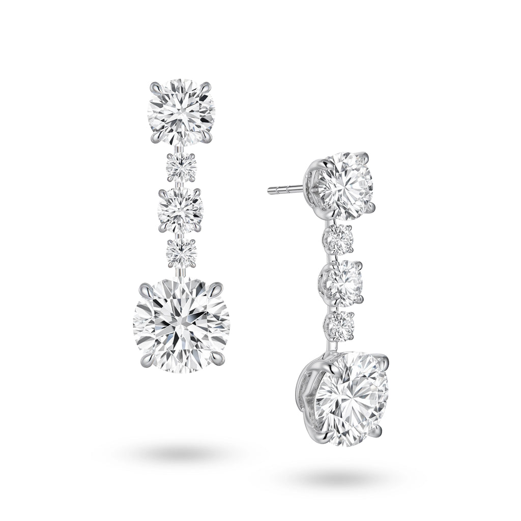 highlighting the refined 18K white gold setting and secure earring posts. This perspective reveals the delicate rhythm and graduating scale of the vertically aligned round diamonds. Meticulously positioned with minimal metal interference, the stones capture light beautifully from every angle to achieve perfect continuity and luminosity.