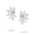 Front view of the J'ENCHANTE The Solaris Bloom high jewelry diamond earrings in 18K white gold. Each earring is anchored by a commanding 3.0-carat round brilliant center stone, from which pear and marquise-cut diamonds unfold in a luminous, petal-like formation (16 diamonds totaling approx. 14.07 carats). This perfectly symmetrical, sculptural bloom embodies the peak of brilliance and striking power.