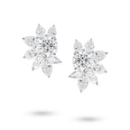 Front view of the J'ENCHANTE The Solaris Bloom high jewelry diamond earrings in 18K white gold. Each earring is anchored by a commanding 3.0-carat round brilliant center stone, from which pear and marquise-cut diamonds unfold in a luminous, petal-like formation (16 diamonds totaling approx. 14.07 carats). This perfectly symmetrical, sculptural bloom embodies the peak of brilliance and striking power.