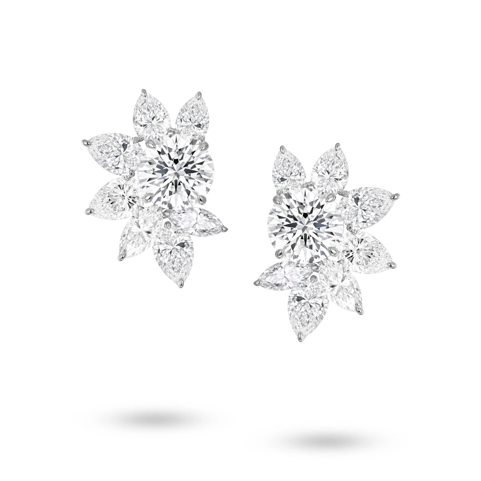 Front view of the J'ENCHANTE The Solaris Bloom high jewelry diamond earrings in 18K white gold. Each earring is anchored by a commanding 3.0-carat round brilliant center stone, from which pear and marquise-cut diamonds unfold in a luminous, petal-like formation (16 diamonds totaling approx. 14.07 carats). This perfectly symmetrical, sculptural bloom embodies the peak of brilliance and striking power.