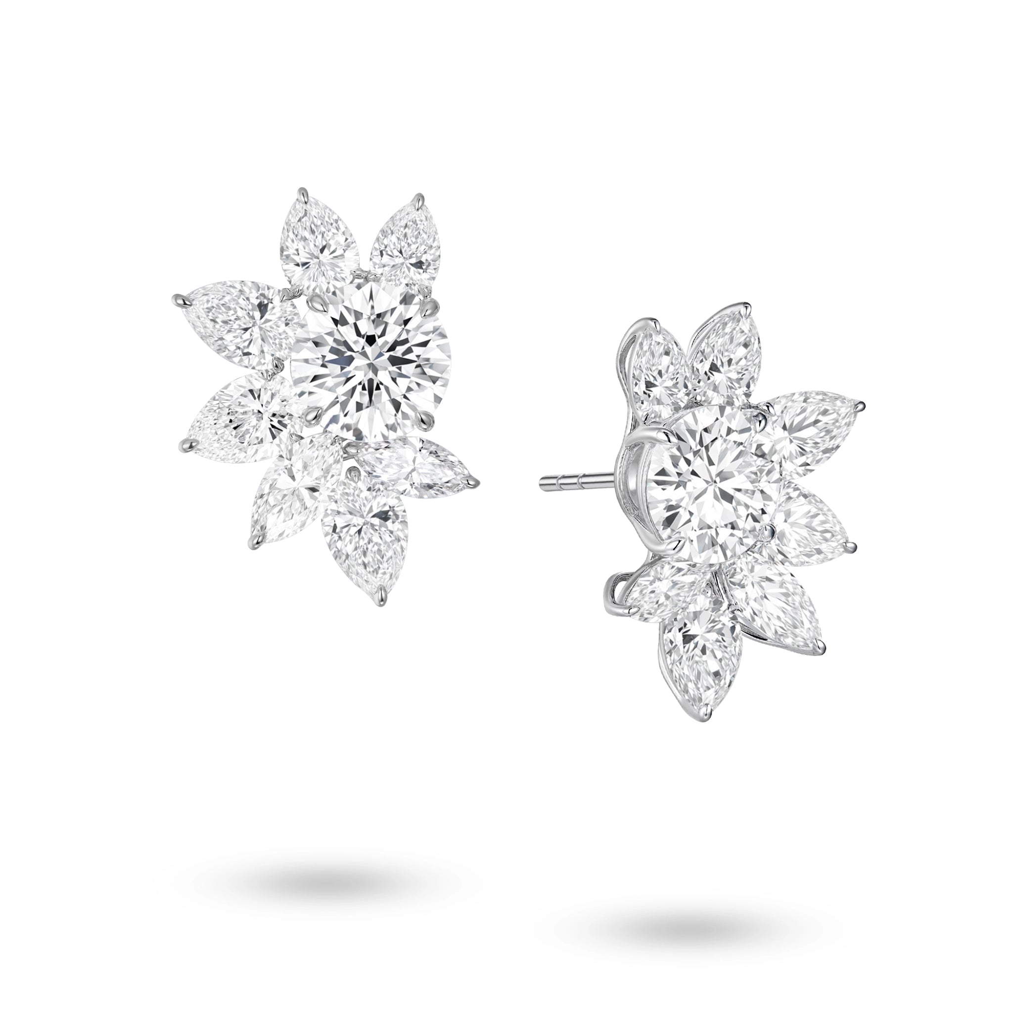 Angled view of the J'ENCHANTE The Solaris Bloom statement diamond earrings. The image highlights the 18K white gold setting and secure earring posts. This perspective reveals the striking three-dimensional depth and the intricate interplay of round, pear, and marquise-cut diamonds. This expertly arranged mixed-cut cluster enhances directional light, ensuring outward brilliance and clarity from every possible angle.